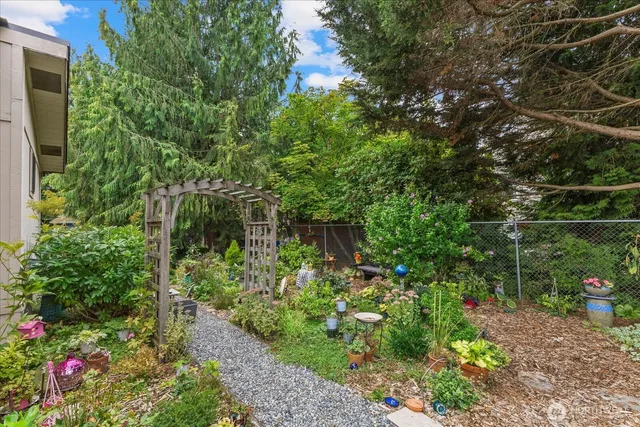 a backyard of a house with lots of green space and trees all around