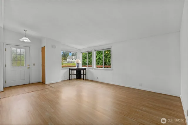 an empty room with furniture and a window