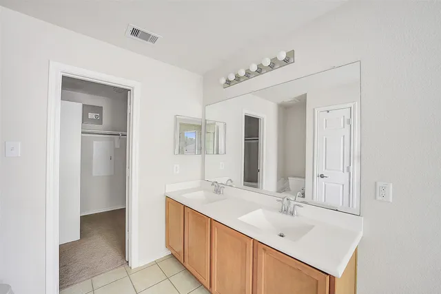 a bathroom with a sink a mirror and a shower