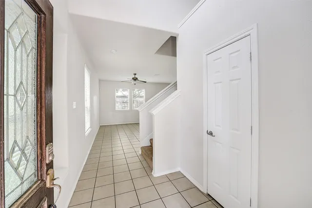 a view of a hallway view with wooden floor and staircase