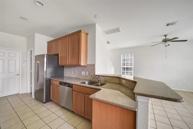 a kitchen that has a sink and a stove