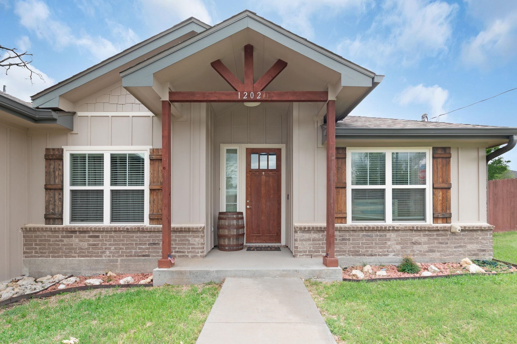 a front view of a house with garden