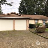 a view of a house with a yard and garage