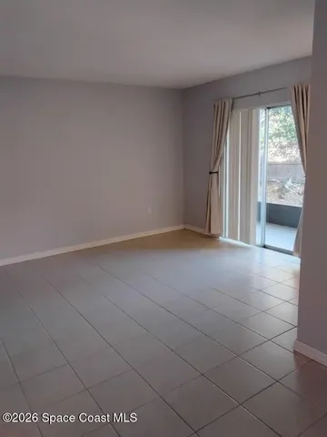 an empty room with large windows