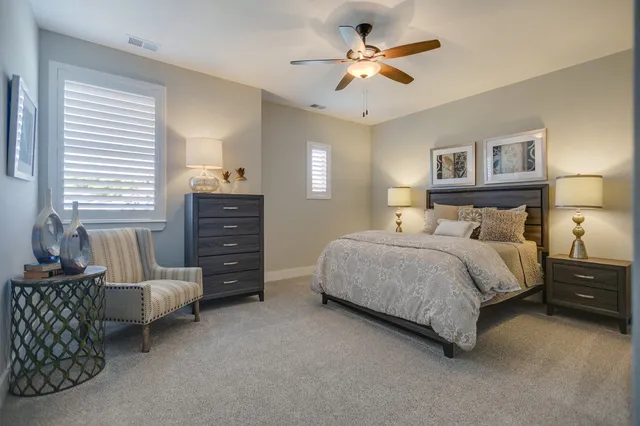 a bedroom with a bed and a dresser