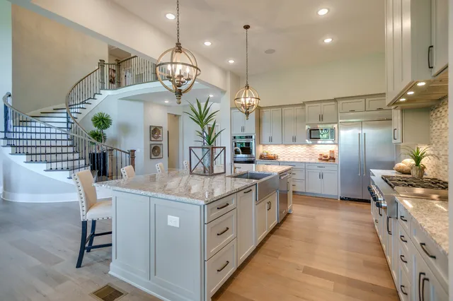 a kitchen with kitchen island granite countertop lots of counter top space and stainless steel appliances