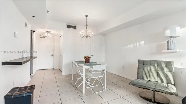 a view of a dining room with furniture and chandelier
