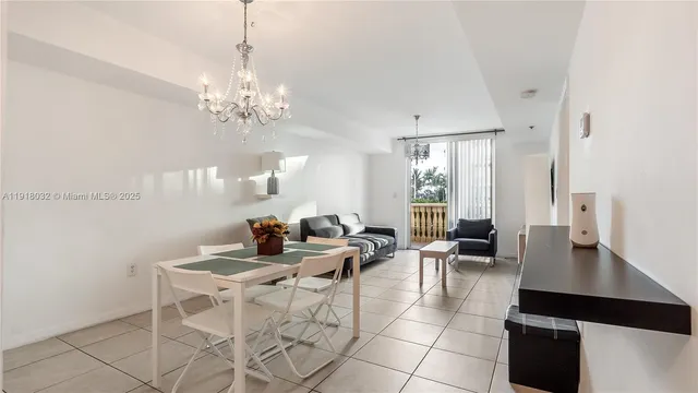 a living room with fireplace furniture and a chandelier