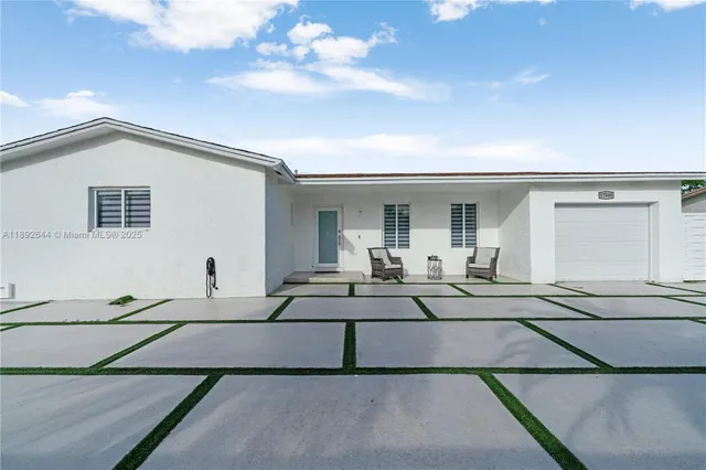 a view of a car park in front of house