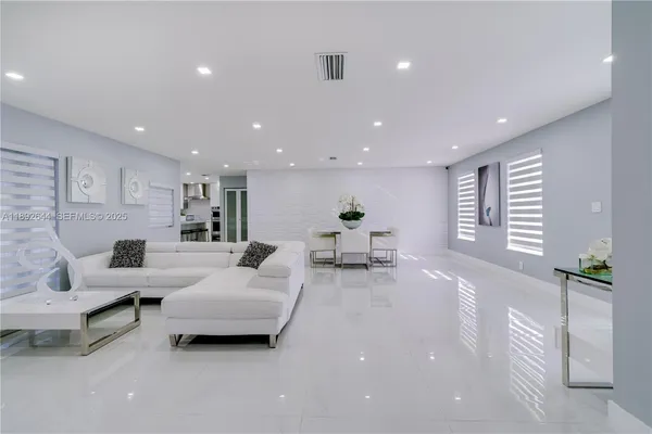 a living room with furniture and a large window
