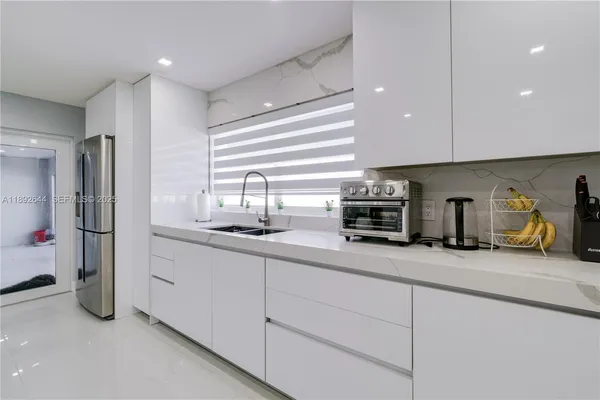 a kitchen with refrigerator and cabinets