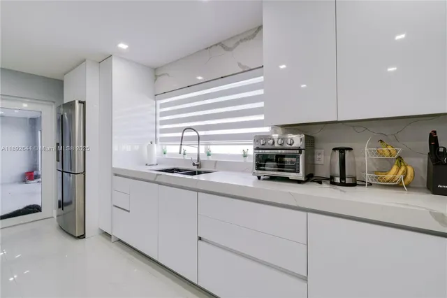 a kitchen with refrigerator and cabinets