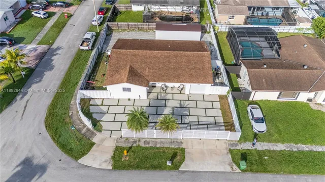 an aerial view of a residential houses with outdoor space