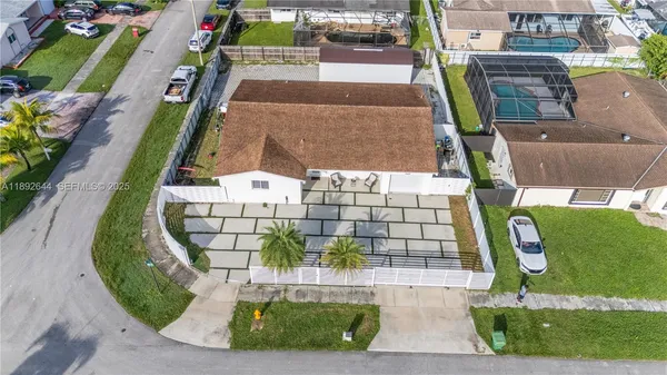 an aerial view of a residential houses with outdoor space