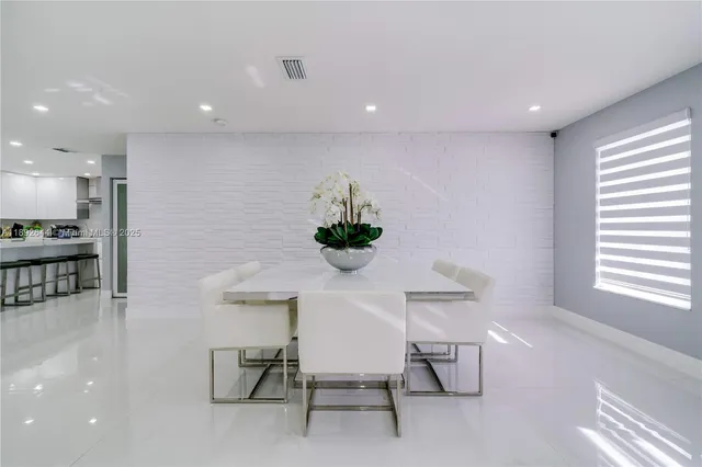 a view of a dining room with furniture and a large window