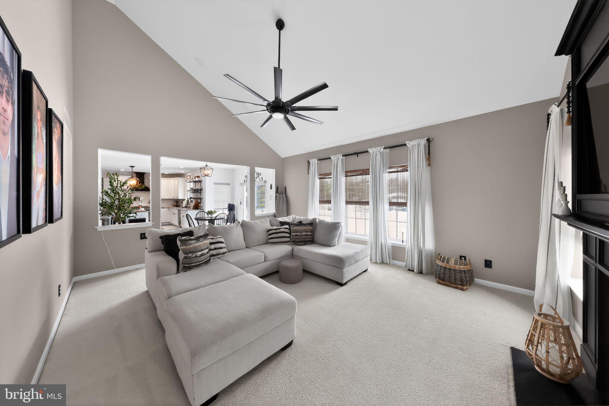 106 Coventry Lane Swedesboro, NJ 08085 - Photo 14 of 38 a living room with furniture a ceiling fan a flat screen tv and a large window