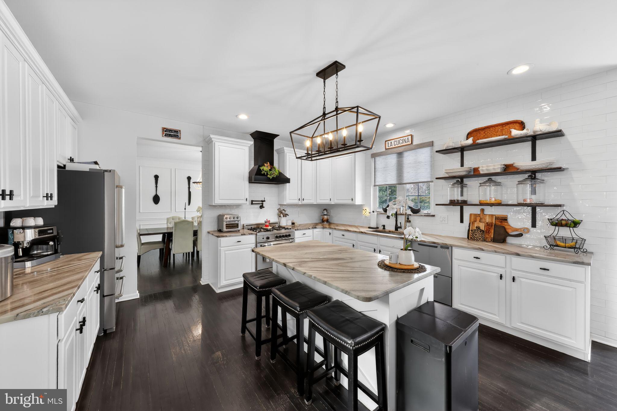 106 Coventry Lane Swedesboro, NJ 08085 - Photo 18 of 38 a kitchen with stainless steel appliances a stove a sink dishwasher and a refrigerator with wooden floor