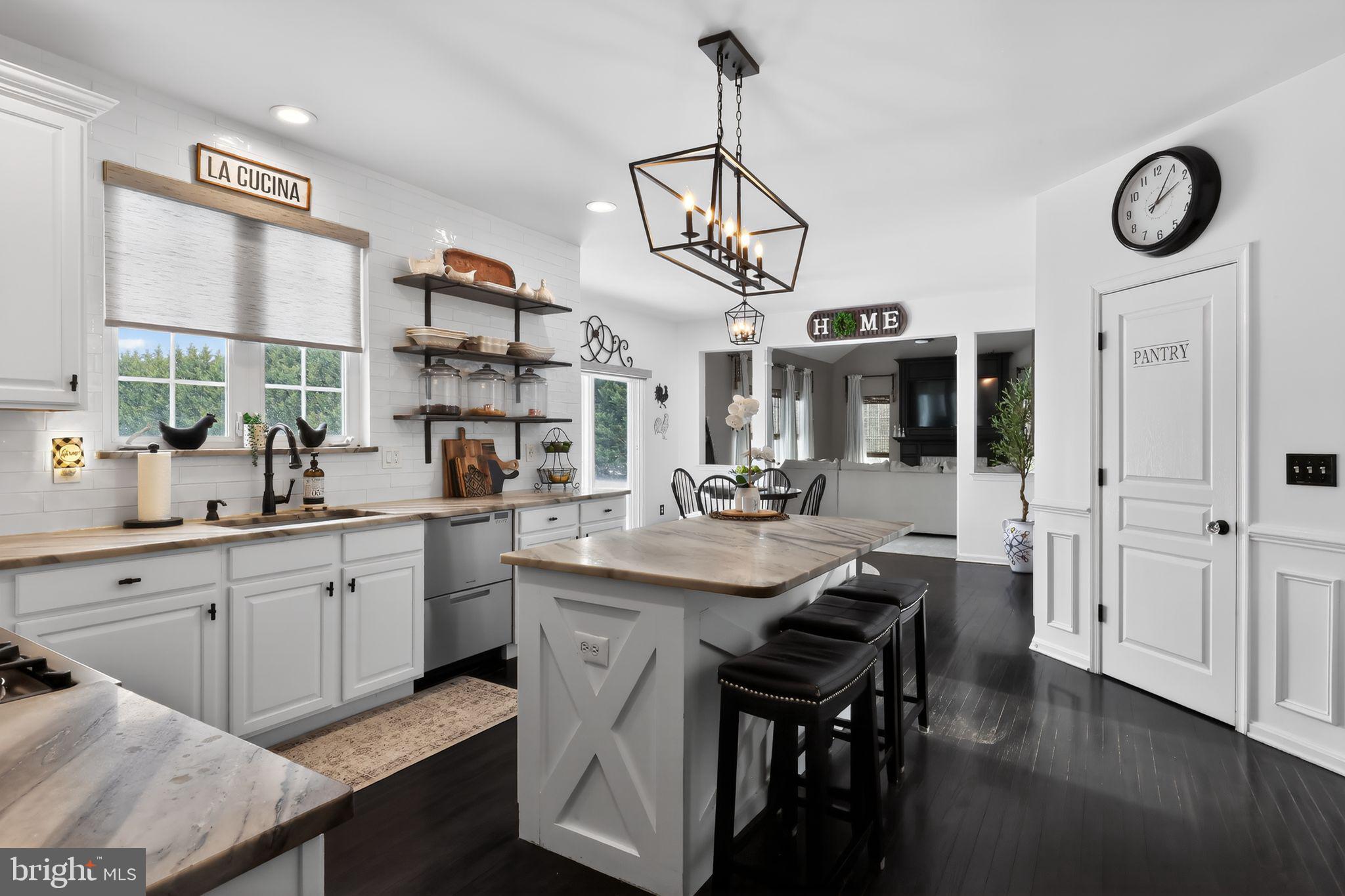 106 Coventry Lane Swedesboro, NJ 08085 - Photo 20 of 38 a kitchen with stainless steel appliances granite countertop a sink a stove a refrigerator and wooden floor