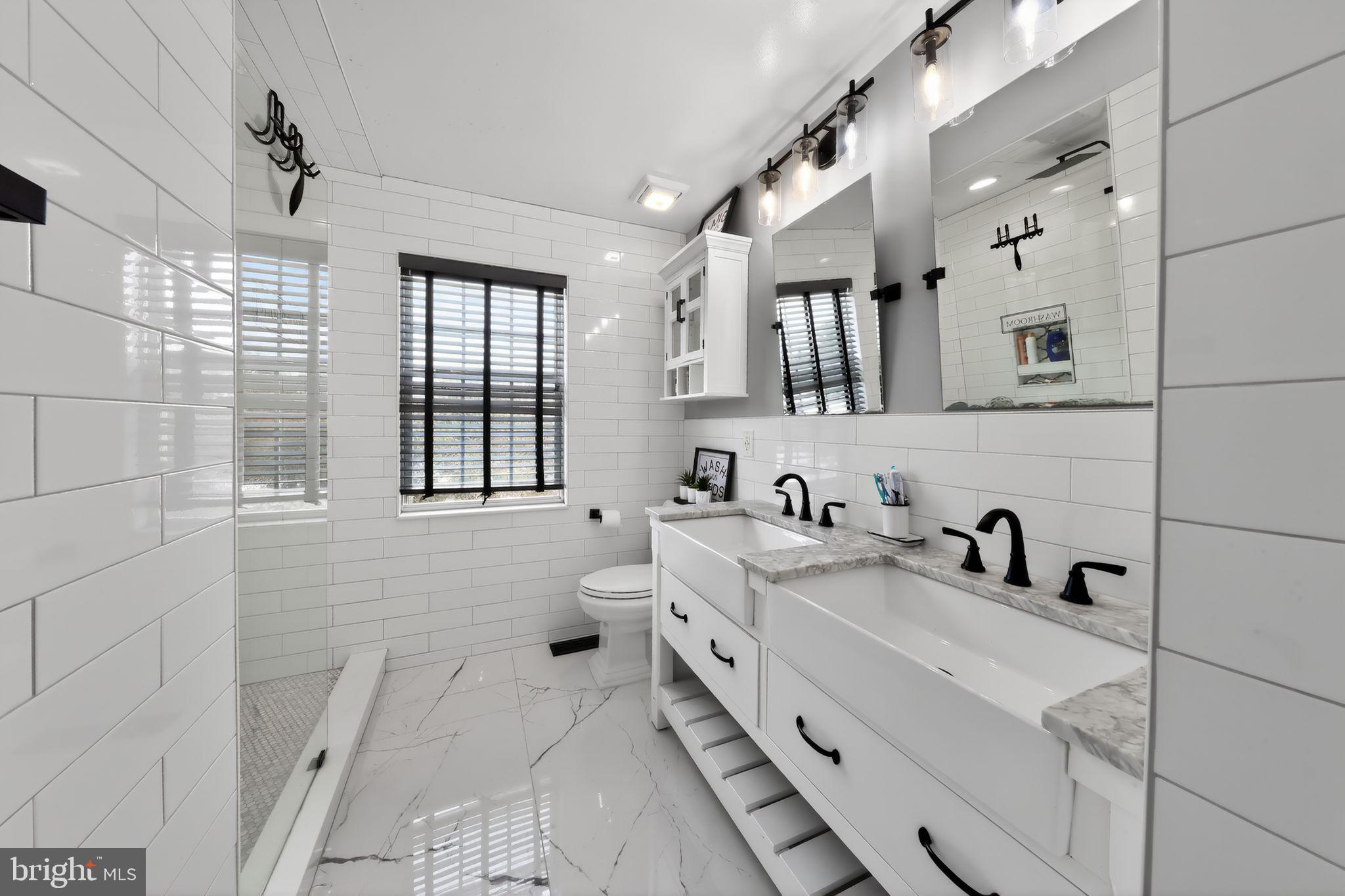 106 Coventry Lane Swedesboro, NJ 08085 - Photo 32 of 38 a bathroom with a sink mirror and a bathtub