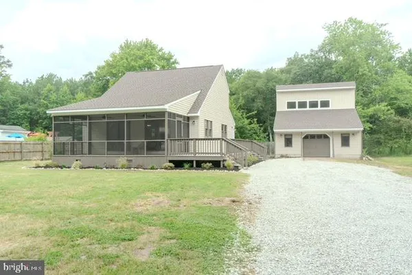 a kitchen with stainless steel appliances a sink a microwave a refrigerator and a counter space