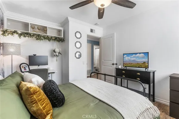 a bedroom with a bed and a chandelier