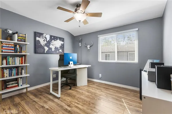 a workspace with furniture bookshelf and a window