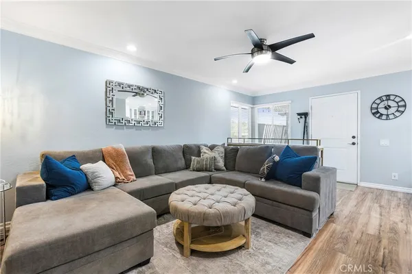 a living room with furniture and a ceiling fan