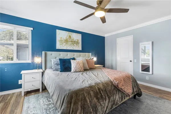 a bedroom with a bed and a chandelier