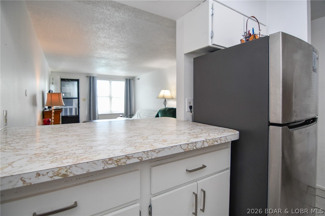 1118 Passover Road, Unit E216 Osage Beach, MO 65065 - Photo 12 of 31 Pass-thru counter at the kitchen