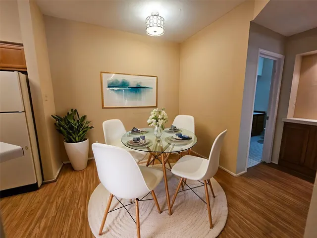 a view of a dining room with furniture and wooden floor