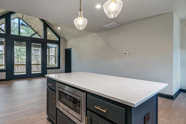 a kitchen with a stove and a large window