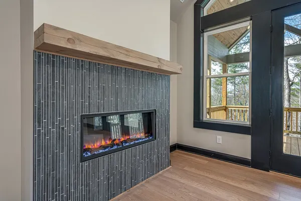 a living room with a fireplace and a wooden floor