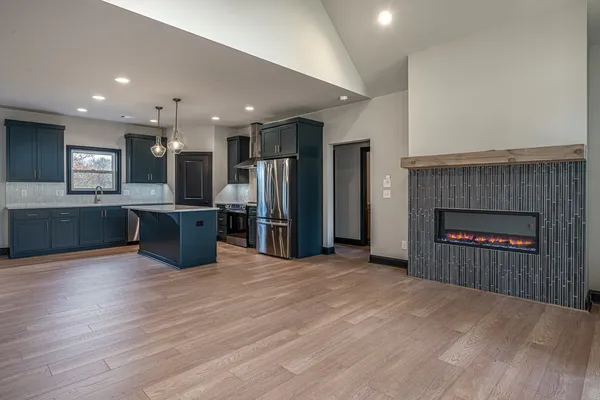 a view of a kitchen with a sink and a fireplace