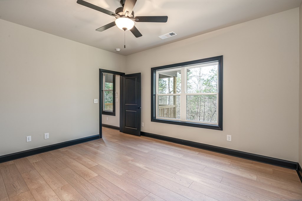 325 River Mountain Road Murphy, NC 28906 - Photo 20 of 57 a view of an empty room with a window and wooden floor