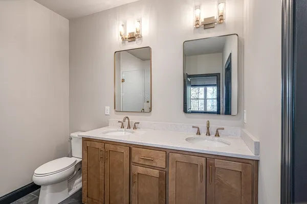 a bathroom with 2 sink and a toilet