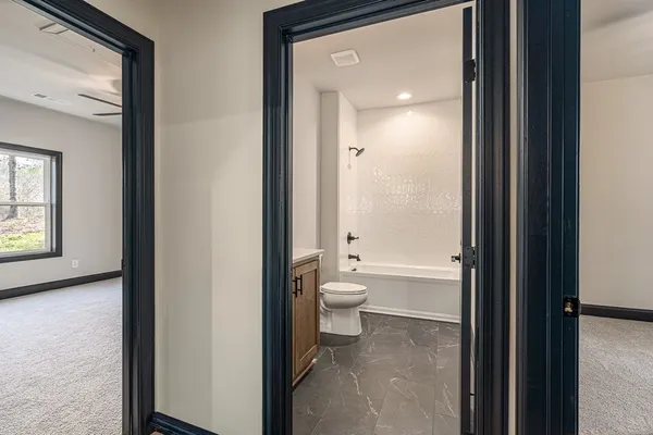 a bathroom with a toilet tub shower and sink