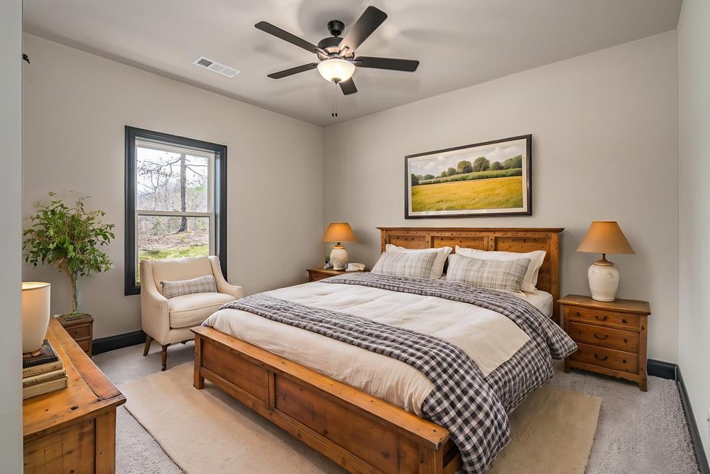 325 River Mountain Road Murphy, NC 28906 - Photo 25 of 57 a bedroom with a bed and a chandelier
