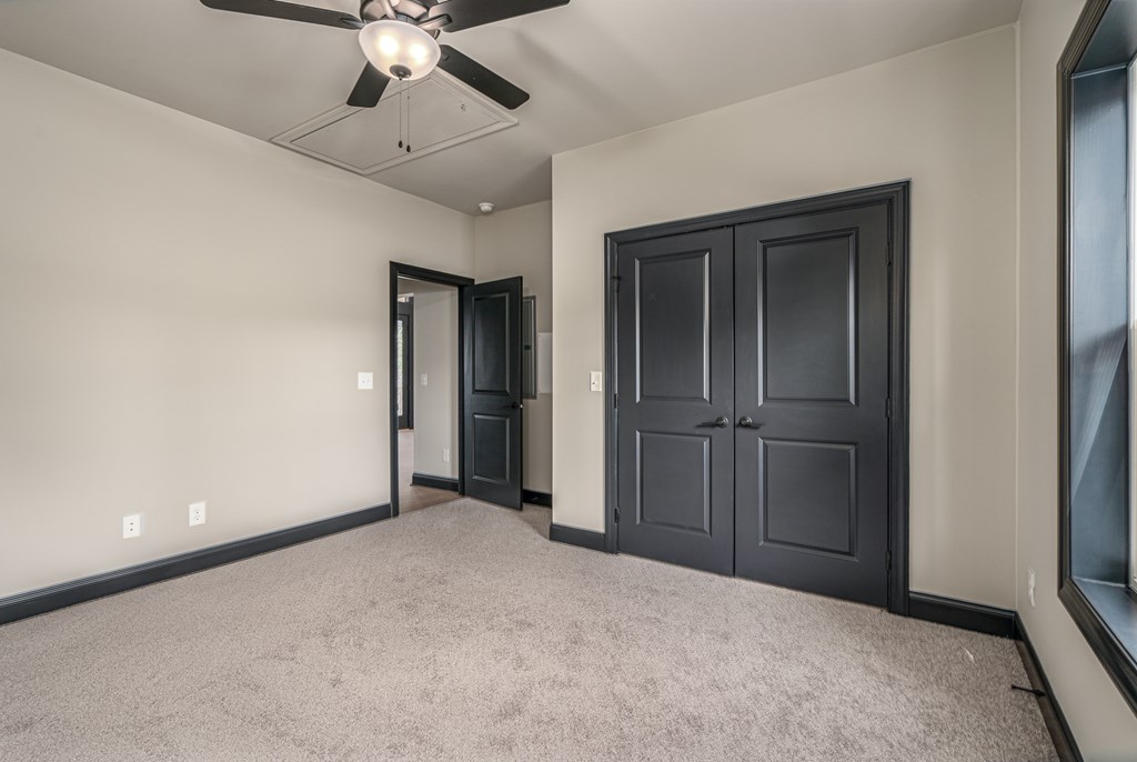 325 River Mountain Road Murphy, NC 28906 - Photo 27 of 57 an empty room with closet and a ceiling fan