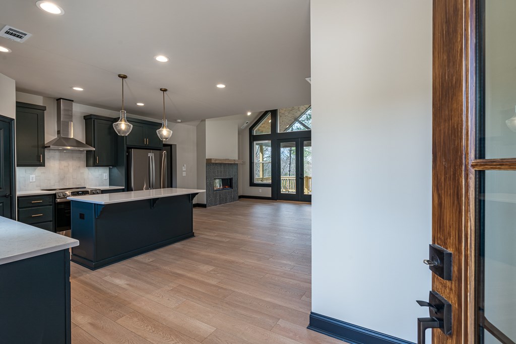 325 River Mountain Road Murphy, NC 28906 - Photo 4 of 57 a large kitchen with stainless steel appliances kitchen island a large counter top and a wooden floor