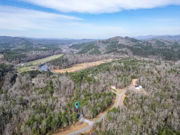 a view of a house with a yard covered in snow