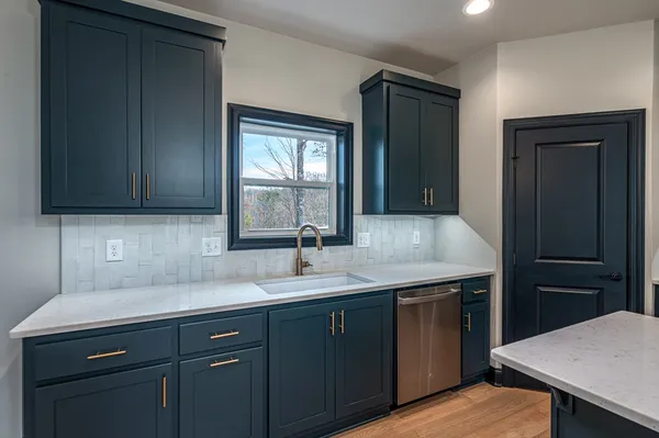 a kitchen with a sink and cabinets