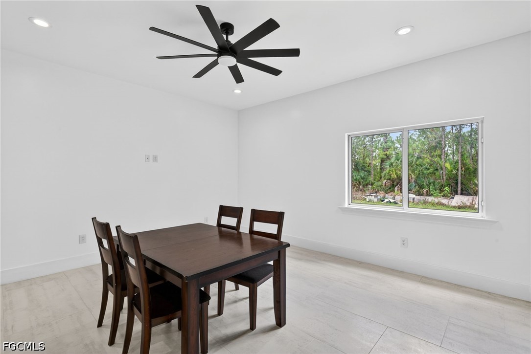 2665 Oil Well Road Naples, FL 34120 - Photo 6 of 40 a view of a dining room with a table and a chairs