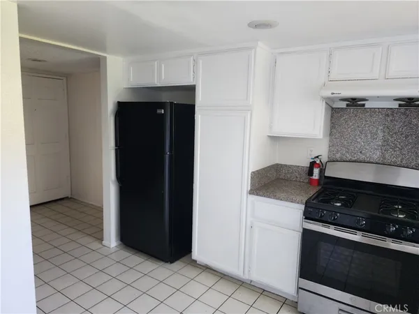 a kitchen with a stove and a refrigerator
