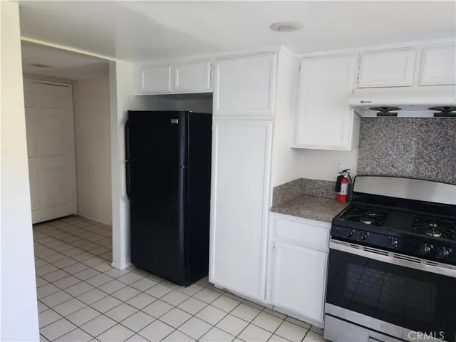 a kitchen with a stove and a refrigerator