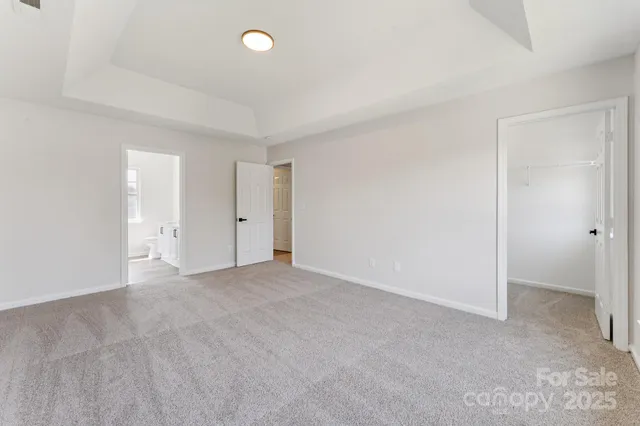 an empty room with an entryway and closet area