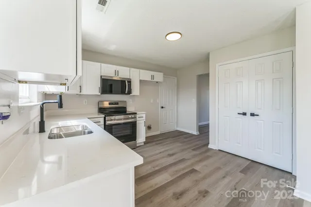 a kitchen with a refrigerator stove and a sink