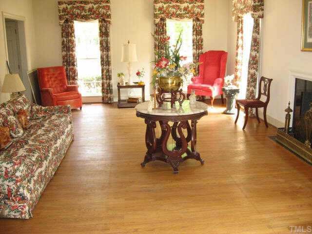 3306 Sussex Road Raleigh, NC 27612 - Photo 2 of 10 a living room with furniture and a fireplace