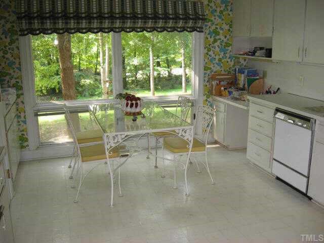 3306 Sussex Road Raleigh, NC 27612 - Photo 6 of 10 a dining room with furniture and a floor to ceiling window