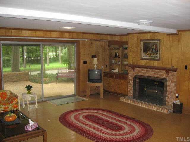 3306 Sussex Road Raleigh, NC 27612 - Photo 9 of 10 a room with furniture and a fireplace