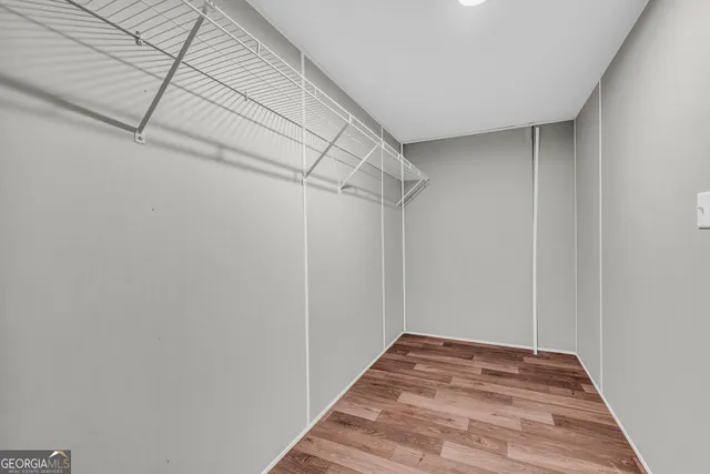 a view of a house with backyard and trees